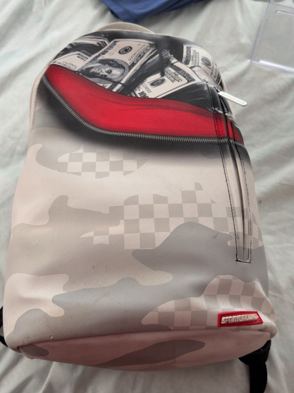 Sprayground Grey Camo Backpack with Red Zip Accent